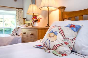 Pretty cushions and linens in bedroom 2.