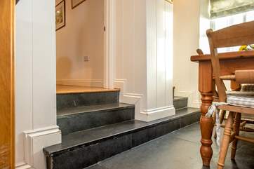 Steps lead down from the sitting-rooms to the kitchen/dining-room.