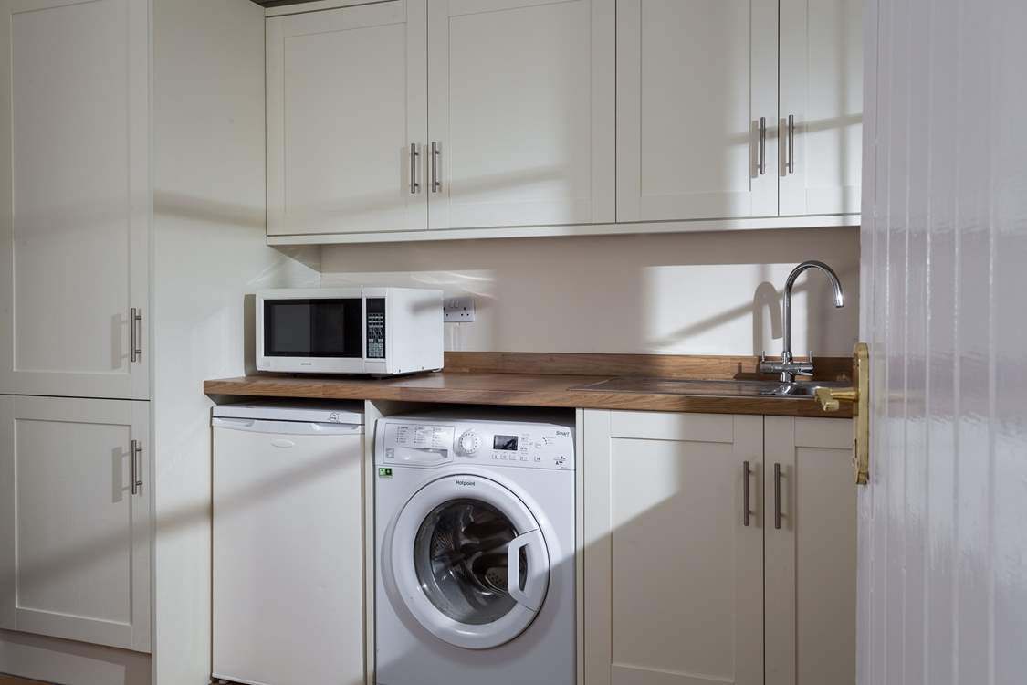 The utility-room and downstairs WC are also located in the sun-room.