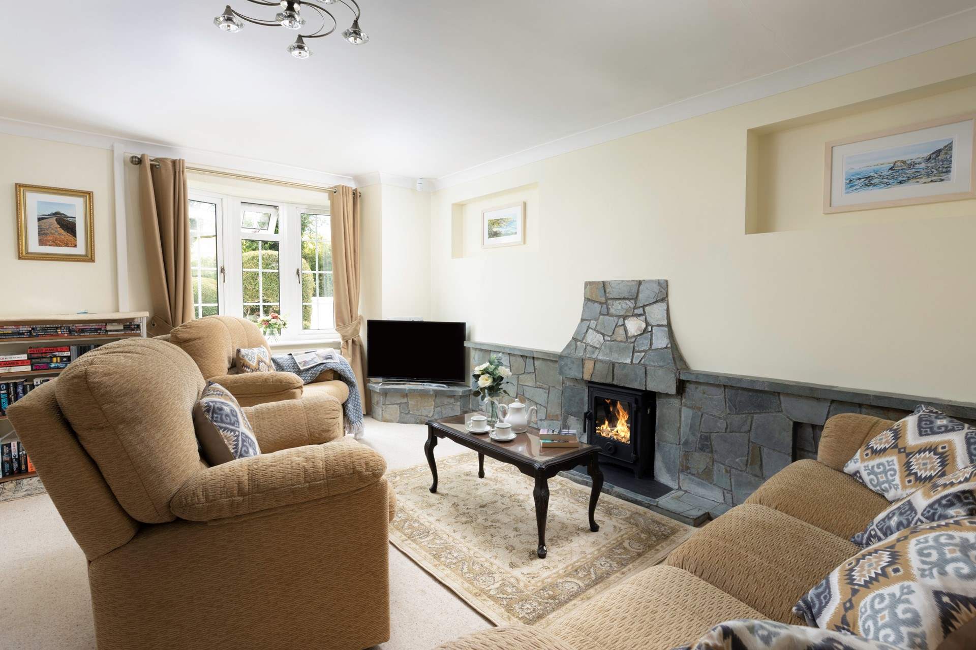 The cosy sitting-room with its toasty wood-burner makes this a perfect retreat all year round. There is a little step leading from the hallway to the front door. 