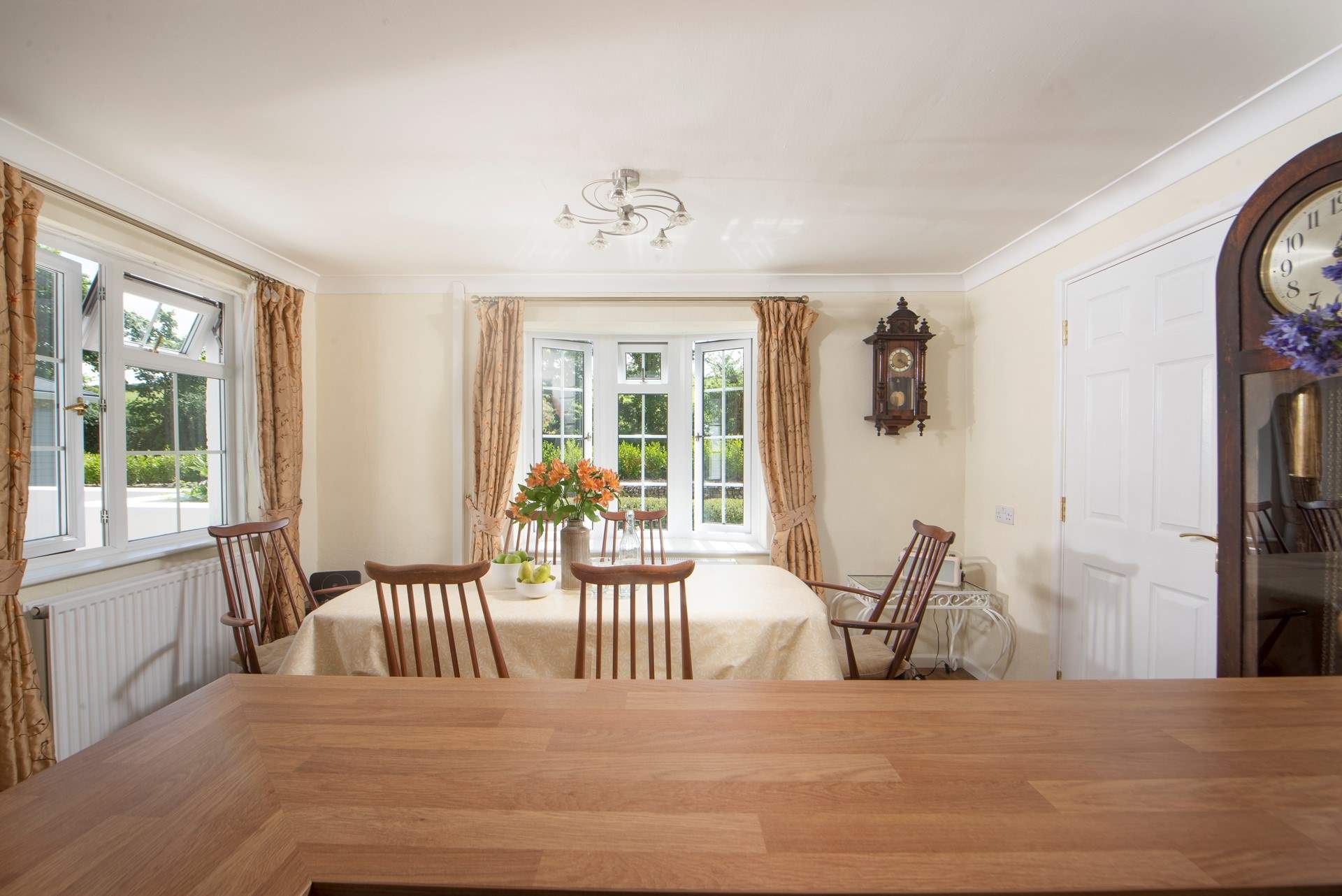 The dining-table overlooks the pretty front garden at Homeleigh. 