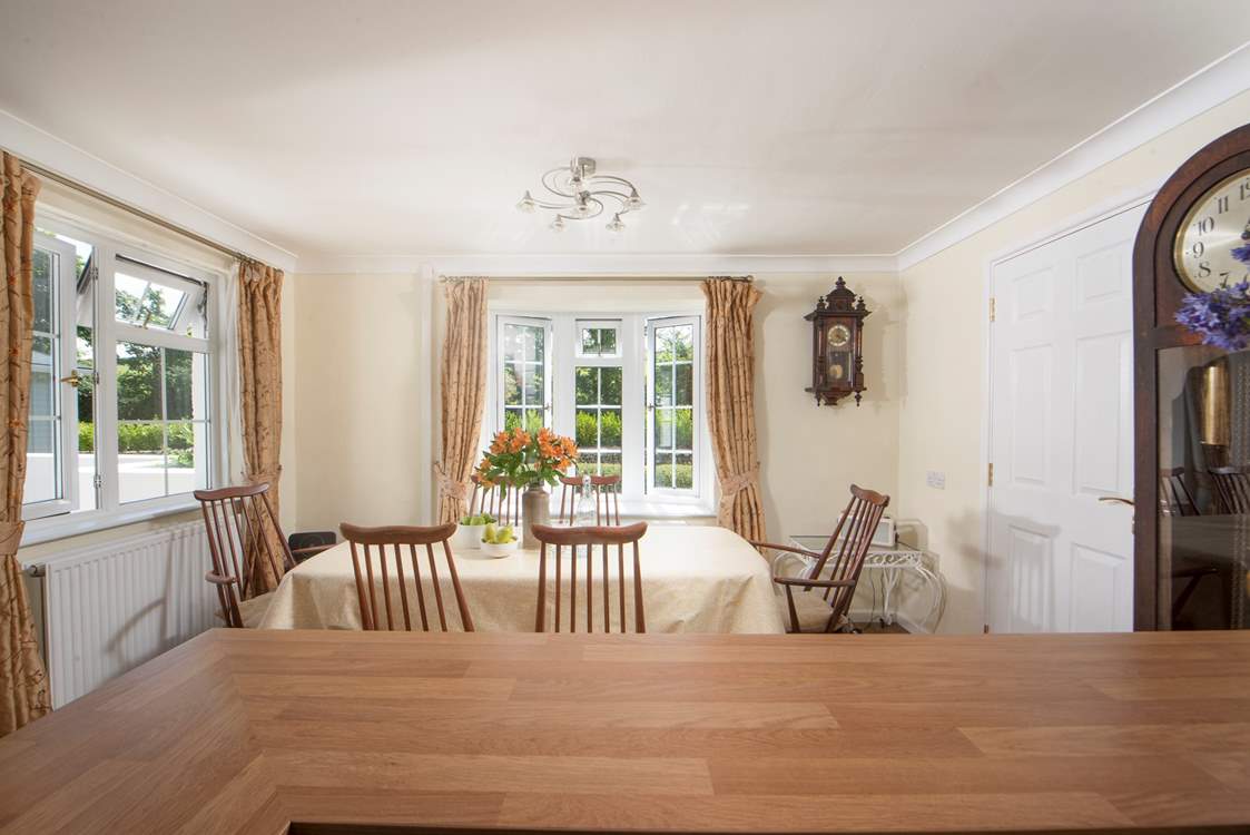 The dining-table overlooks the pretty front garden at Homeleigh.