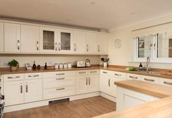 The light and airy kitchen is well-equipped for your every need. 