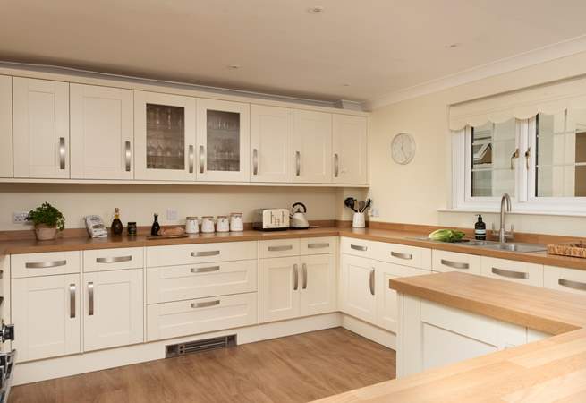 The light and airy kitchen is well-equipped for your every need. 