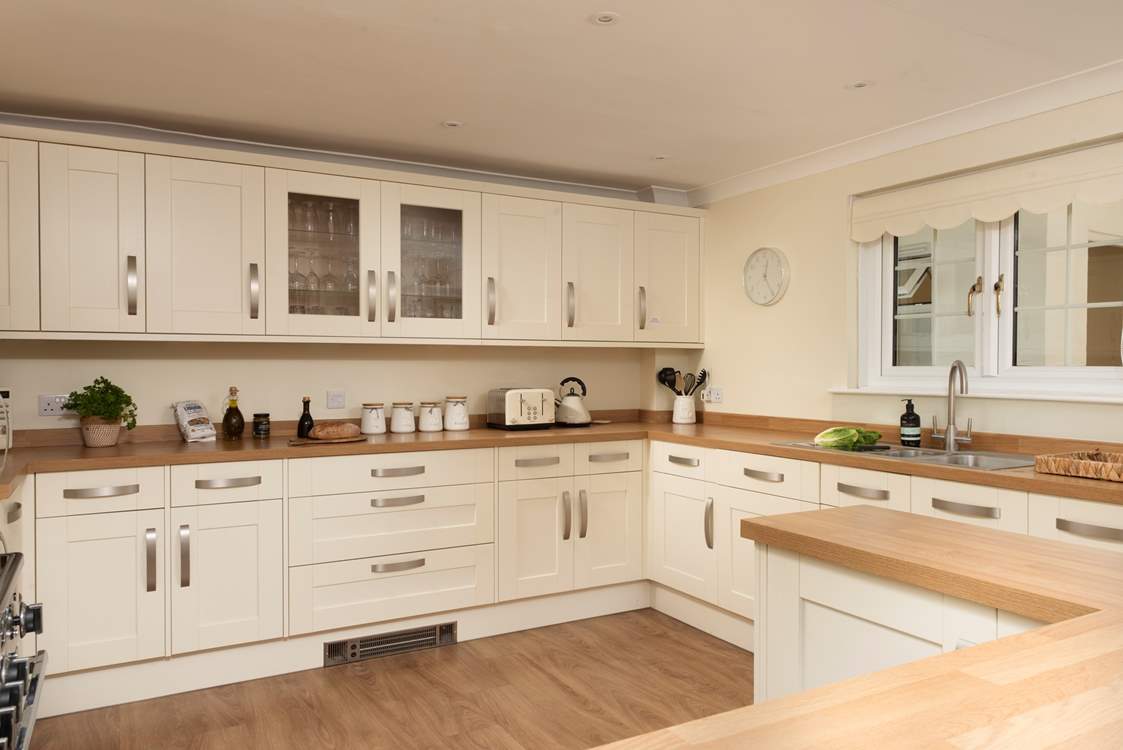 The light and airy kitchen is well-equipped for your every need.
