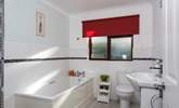 The light and airy family bathroom is located on the ground floor. - Thumbnail Image