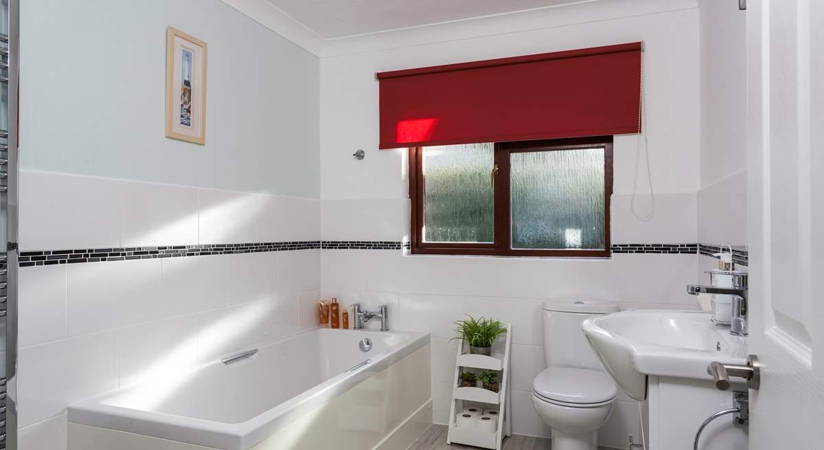 The light and airy family bathroom is located on the ground floor.