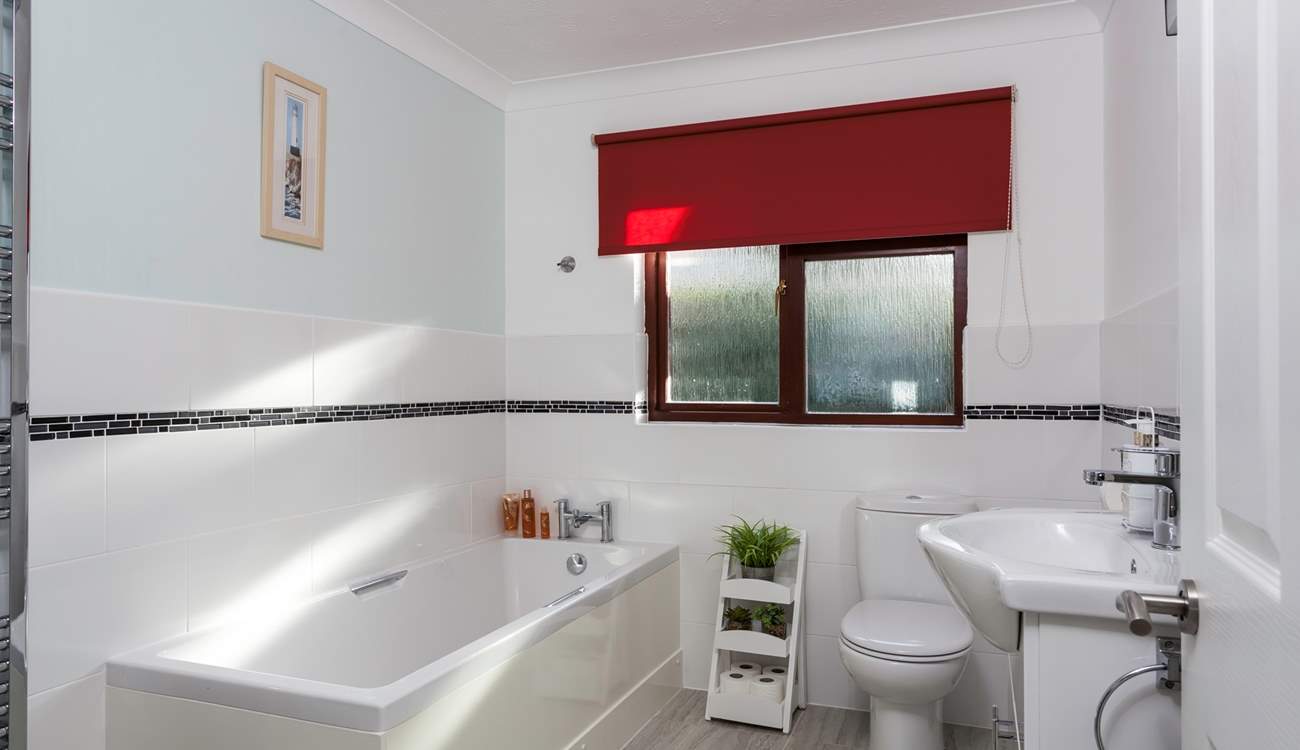 The light and airy family bathroom is located on the ground floor.