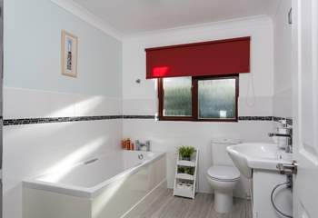 The light and airy family bathroom is located on the ground floor.