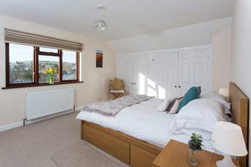The master bedroom is located on the first floor, and overlooks the pretty rear garden.