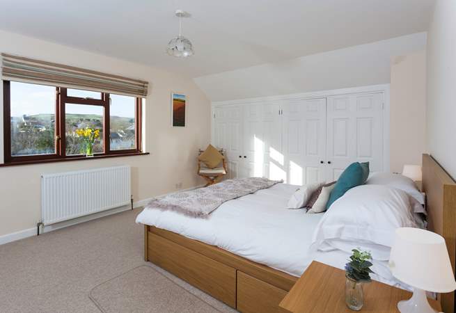 The master bedroom is located on the first floor, and overlooks the pretty rear garden.