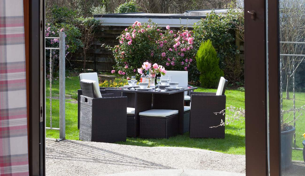 Patio doors open up and lead straight out onto the patio area. There are two steps leading down to the patio and then a further two steps leading onto the lawn.