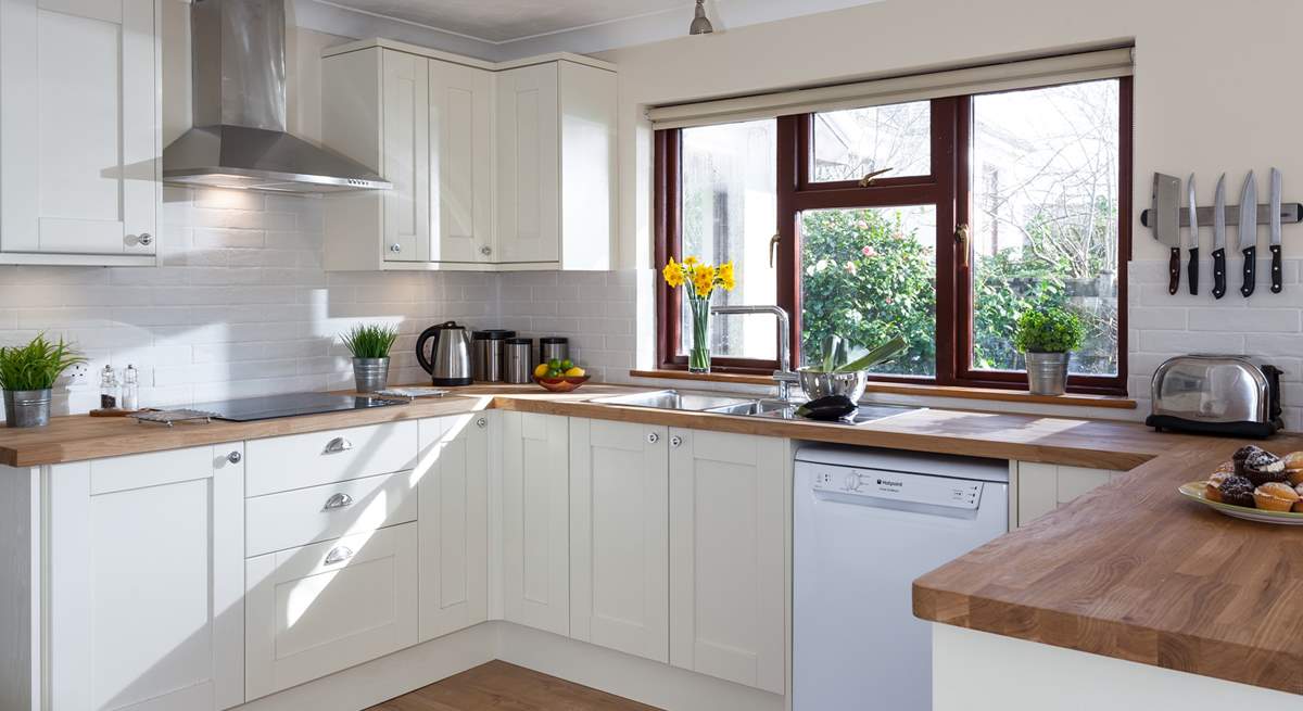 A kitchen with a garden view.