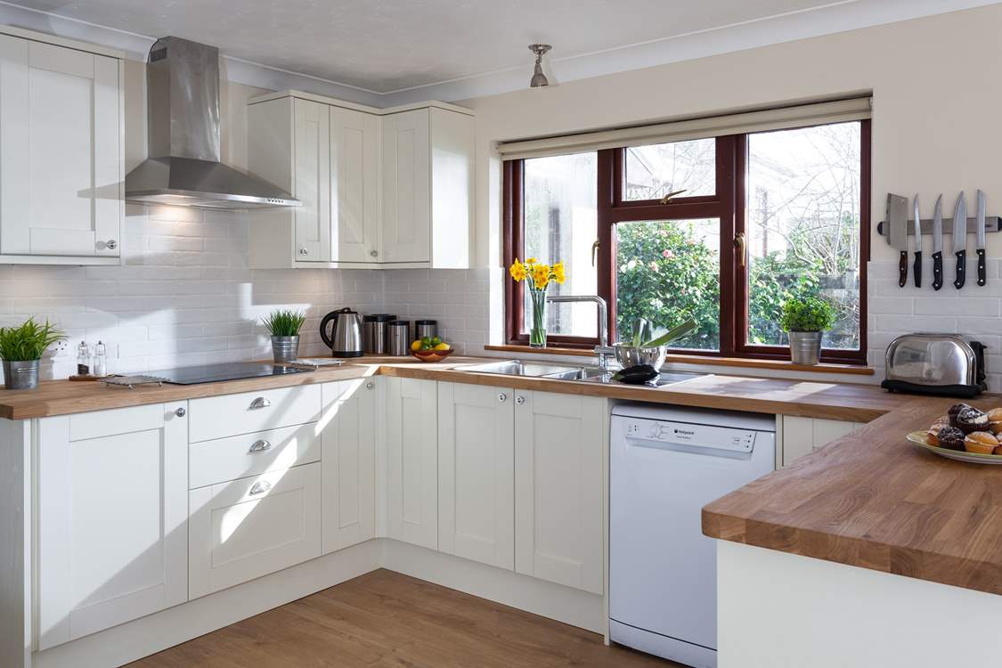 A kitchen with a garden view.