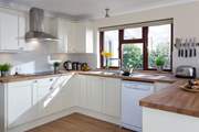 A kitchen with a garden view.
