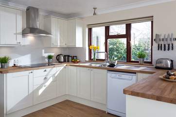 A kitchen with a garden view.