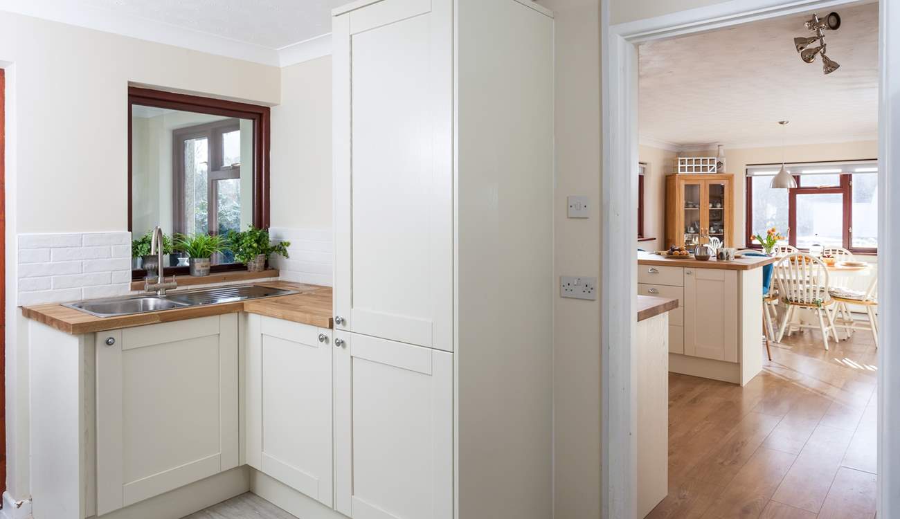 The handy utility-room leads into the kitchen.