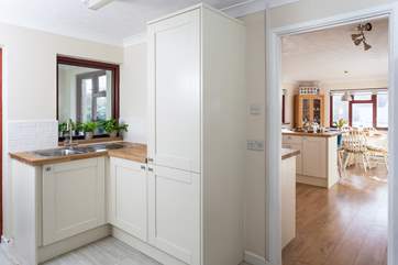 The handy utility-room leads into the kitchen.