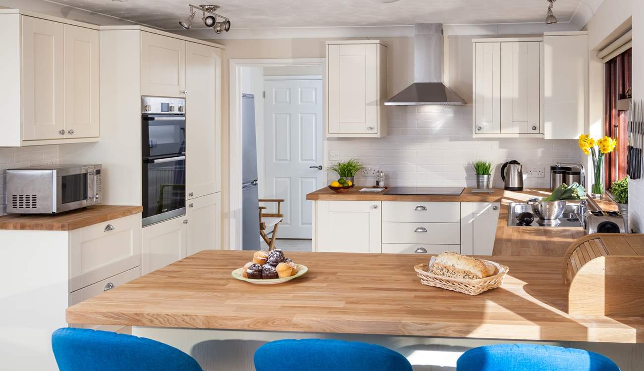 The gorgeous kitchen is very well-equipped.