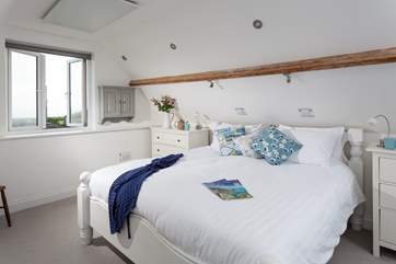 The master bedroom on the first floor has a luxurious super-king bed but feels very cosy with the sloped ceilings (Bedroom 3).