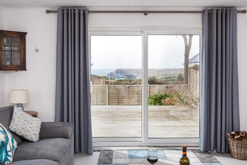 The sitting-room has French windows that open up to a large decking, perfect for those warmer months. 