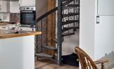 The spiral stairs lead up to the principal bedroom, and under the stairs is the perfect spot for your four-legged friend.  - Thumbnail Image