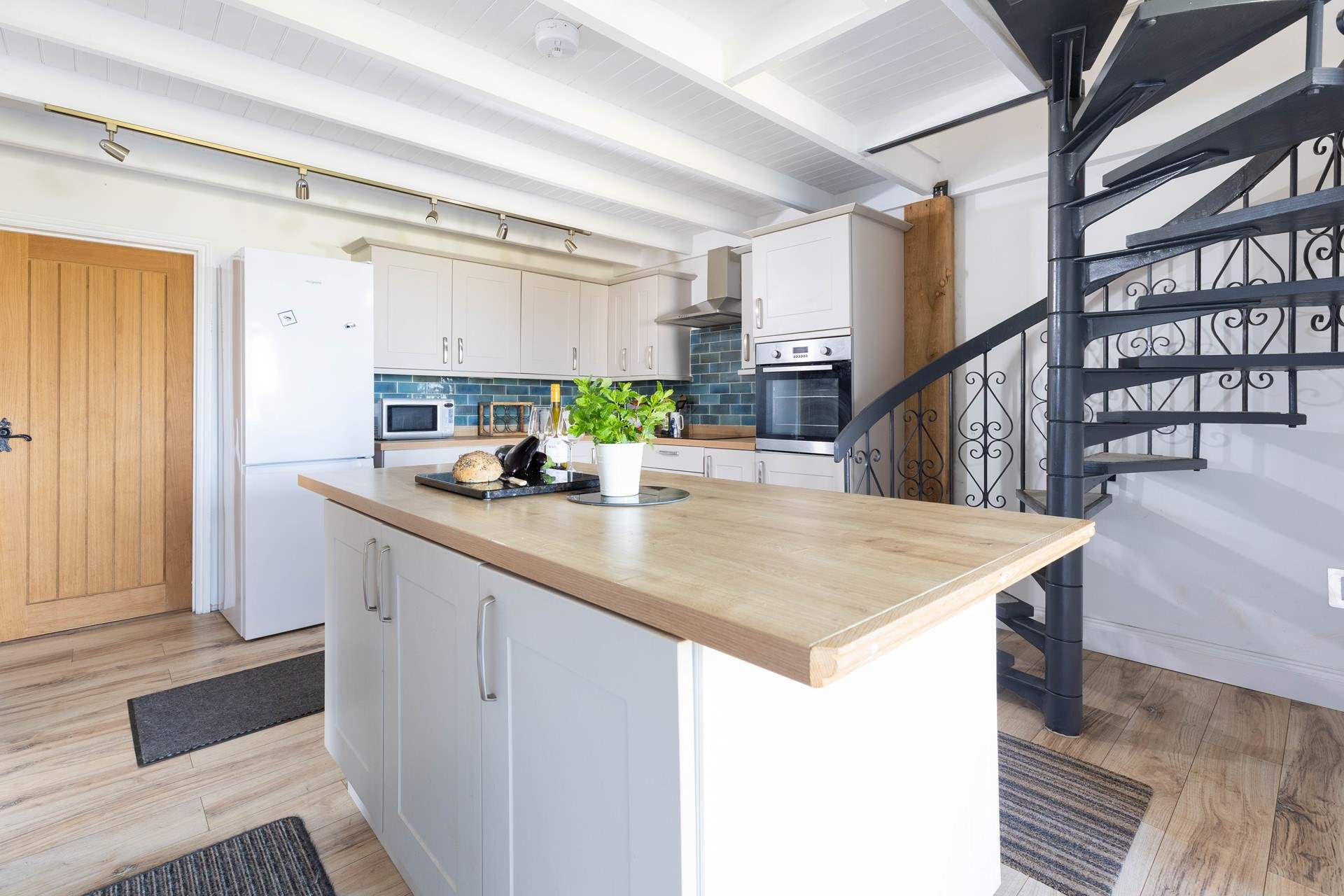 The spiral stairs lead up to the principal bedroom.