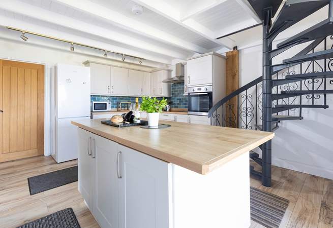 The spiral stairs lead up to the principal bedroom.