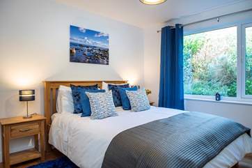 Bedroom 1 in restful shades of blue truly embracing the seaside location.