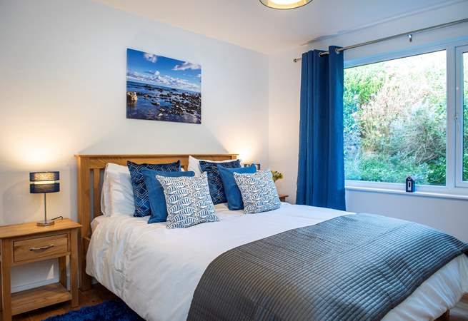Bedroom 1 in restful shades of blue truly embracing the seaside location.