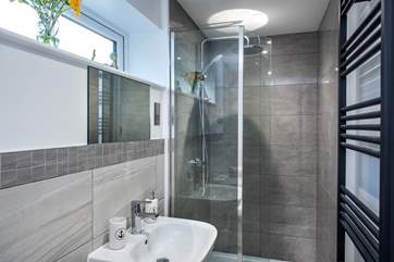 The family bathroom has a drench head shower .