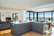 The sleek and modern kitchen complete with a stylish island.