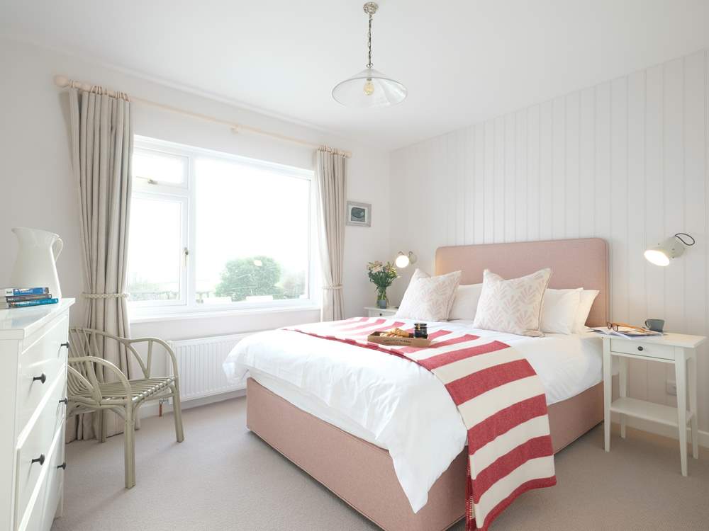 Bedroom 2 has a king-size double bed and views of the sea.