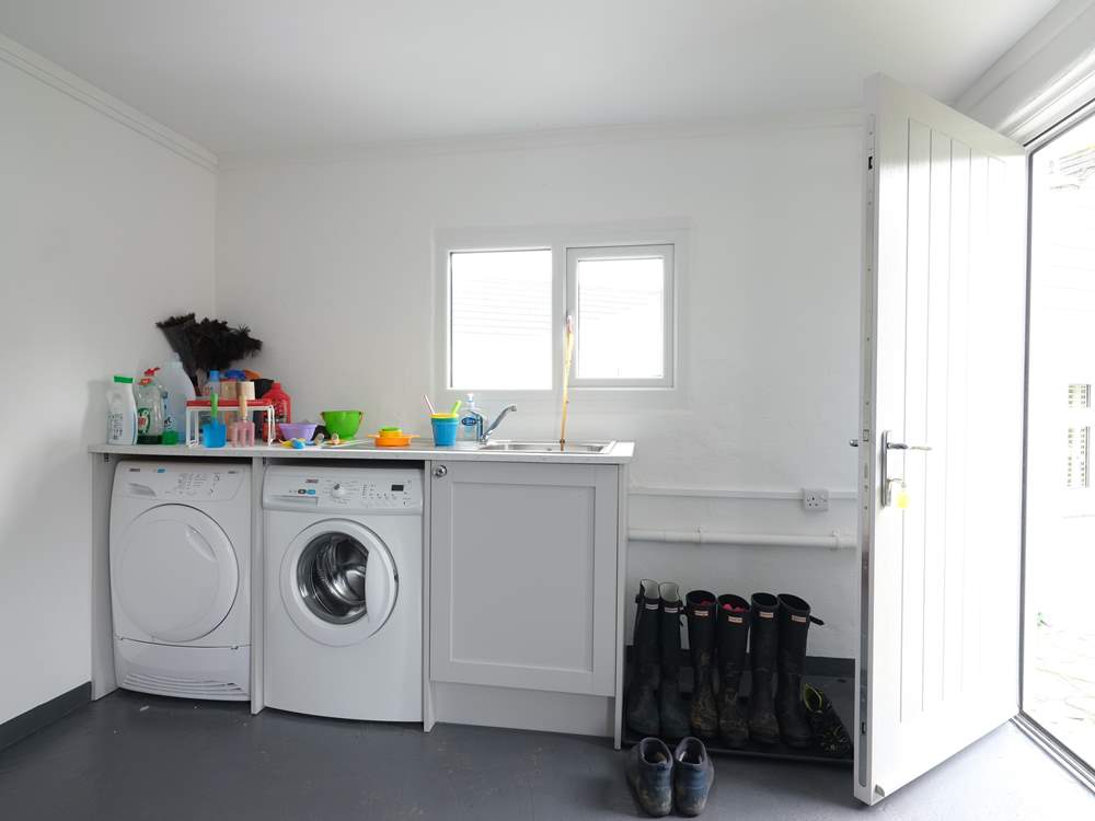 The utility-room in the garage has plenty of space for beach gear.