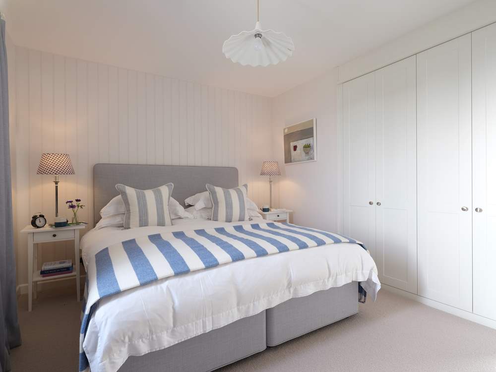 There is plenty of space in the stylish master bedroom.