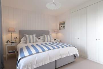 There is plenty of space in the stylish master bedroom.
