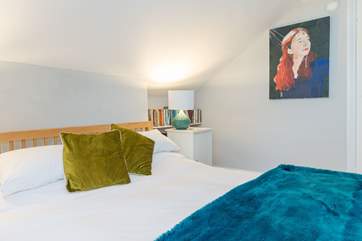 Light and airy, the second floor double bedroom with king-size bed has lovely sea views.