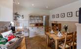 The well-equipped farmhouse-style kitchen and dining area. - Thumbnail Image