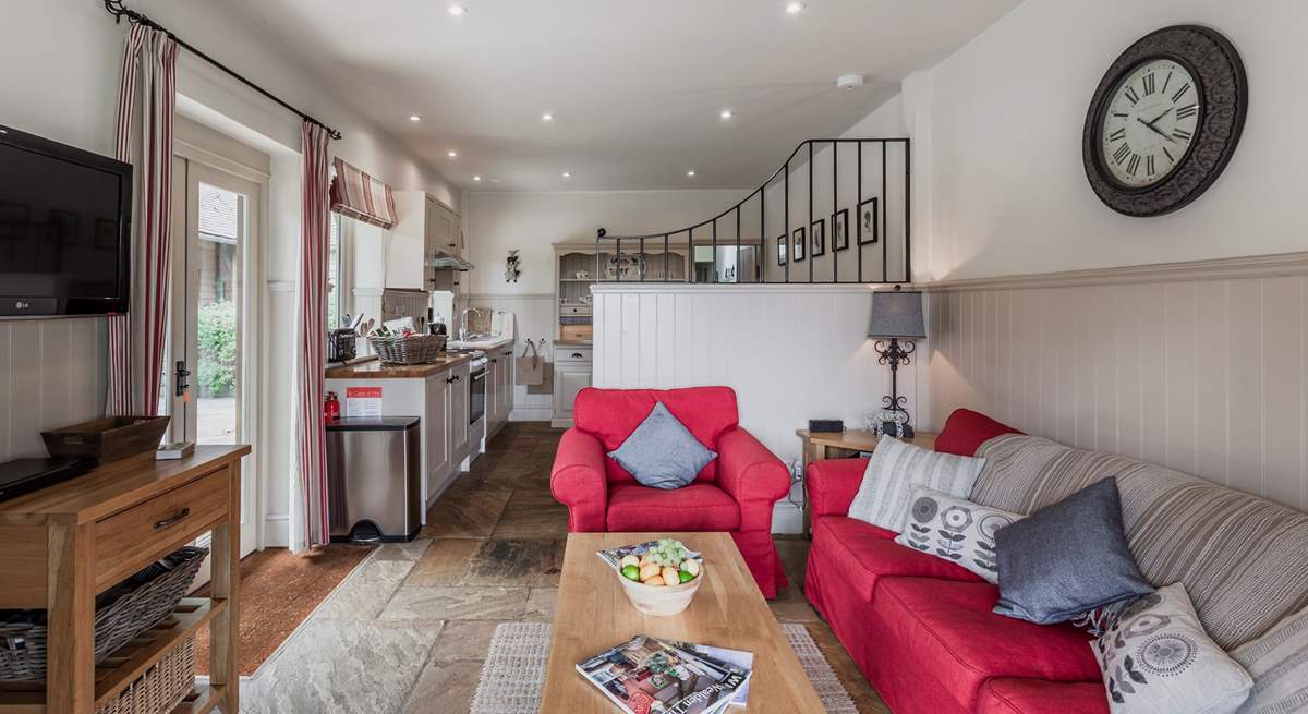 The living space opens onto the kitchen and dining area.