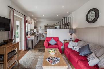The living space opens onto the kitchen and dining area.