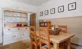 The well-equipped farmhouse-style kitchen and dining area. - Thumbnail Image