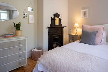 The master bedroom proudly showcases some of the houses original features.