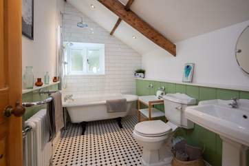 The family bathroom is complemented by a glorious roll-top bath.