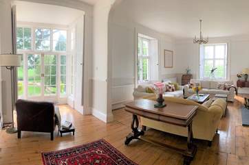 This is the drawing/main sitting-room with its wood-burning stove and views across the gardens. French windows lead directly outside.