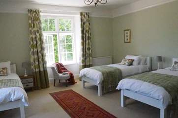 The lovely green bedroom (bedroom 3) with calming colours and views over the garden.