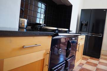 A view of the kitchen with the Aga and large fridge freezer, there is also a double range electric cooker in the kitchen/breakfast room.