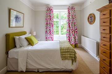 The pretty single bedroom overlooks the garden.