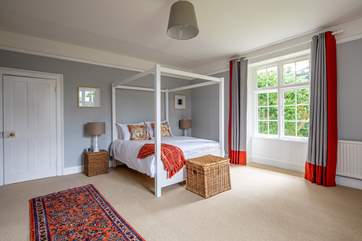 The grey bedroom with four poster bed.