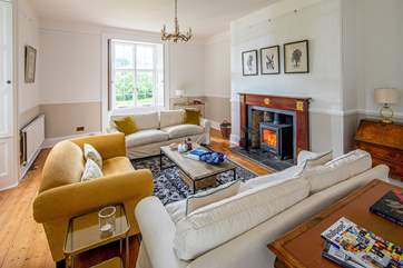 This is the drawing/main sitting-room with its wood-burning stove and views across the gardens. French windows lead directly outside.