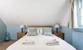 The relaxing blue tones of the bedroom with king-size double bed. - Thumbnail Image